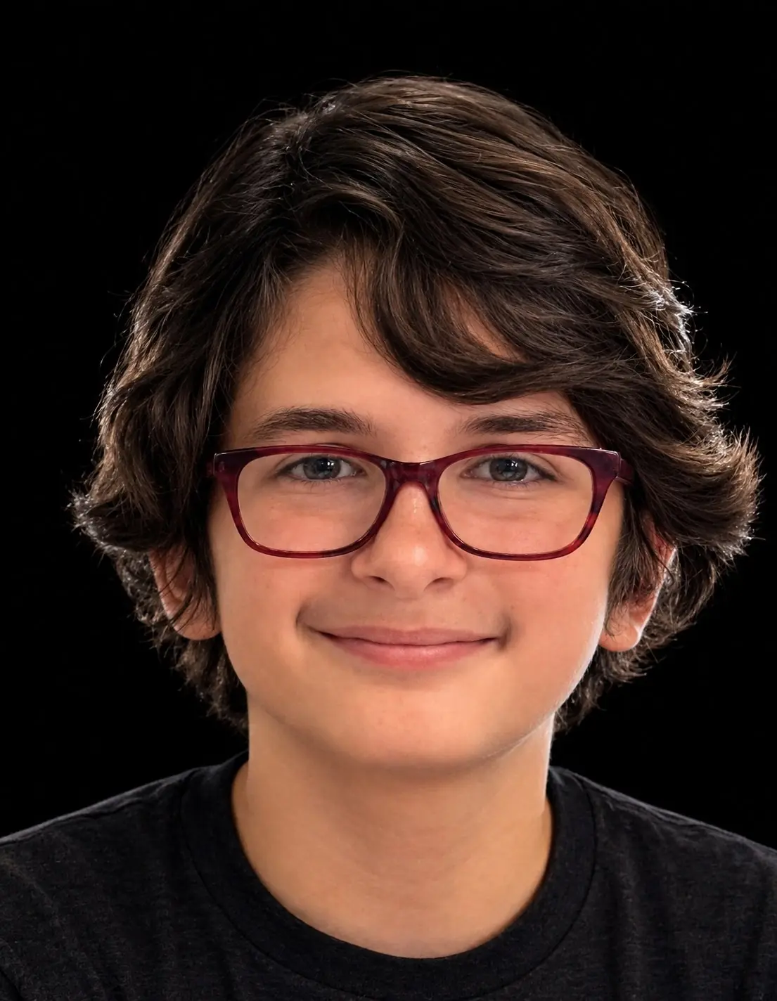 Leonidas Cantrell smiling in a black shirt and glasses against a black background.